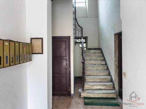 a staircase in an old building with a door at Sea 3 min away - Free Park - Trains 8 min - Air Conditioner in Albisola Superiore