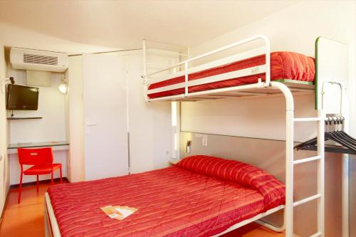 a bedroom with a bunk bed with a red bedspread at Premiere Classe Salon De Provence in Salon-de-Provence