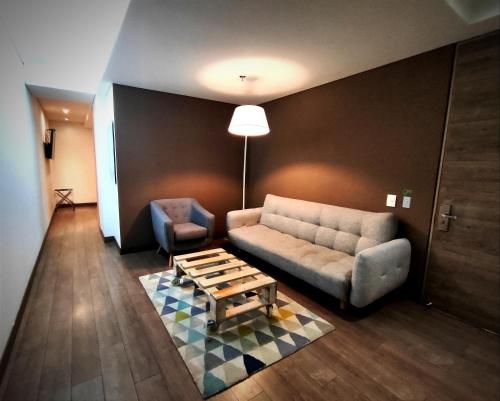 a living room with a couch and a coffee table at Mika Suites in Bogotá