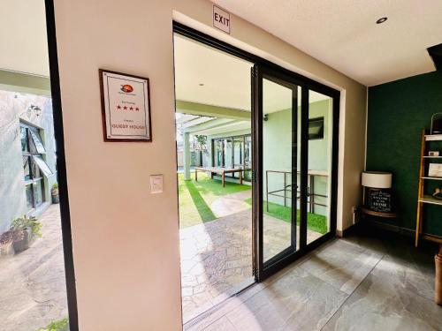 a hallway with a sliding glass door leading to a patio at Little Forest Garden Retreat in Windhoek
