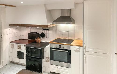 a kitchen with an oven and a stove top at Nice Home In Strömsnäsbruk With Kitchen in Sånnamad