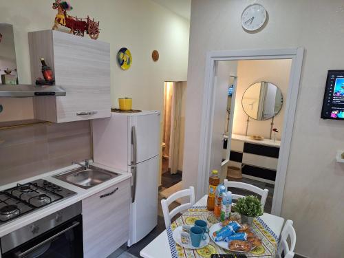 a small kitchen with a table and a sink at Eruption1669 in Catania