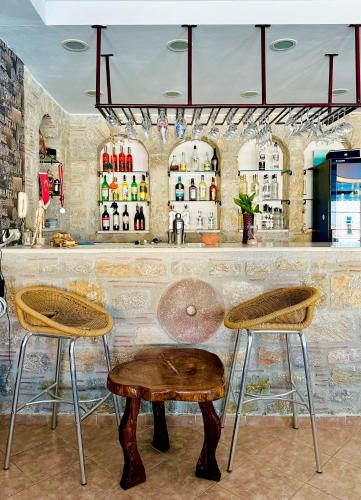 a bar with two stools and a table at Villa Anfora in Datca