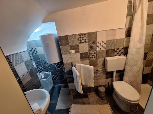 a bathroom with a toilet and a sink at Eruption1669 in Catania