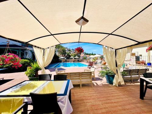 a patio with a table and chairs and a pool at Villa Anfora in Datca