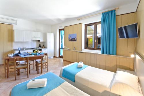 a hotel room with two beds and a kitchen at Resort Santa Maria Hotel in Birgi Vecchi