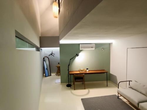 a living room with a table and a couch at FX Stay & Coffee in Yogyakarta