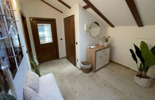 a hallway with a sink and a mirror in a room at Ferienwohnung Bad Reichenhall (Nonn) in Bad Reichenhall