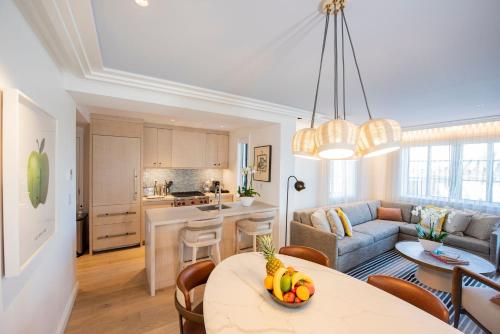 a kitchen and living room with a table and a couch at White Elephant Palm Beach in Palm Beach
