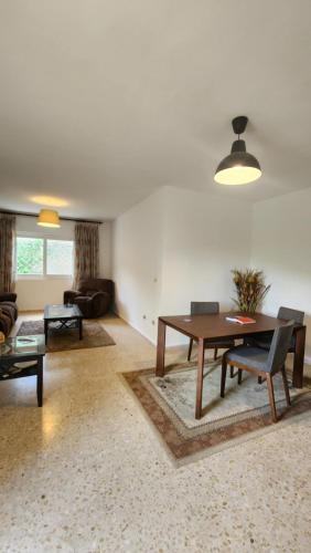 a living room with a table and a couch at Blackbird Sanctuary homestay & Art Cafe in Ajloun