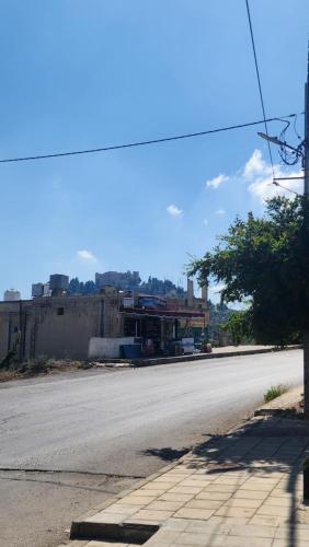 an empty street in front of a building at Blackbird Sanctuary homestay & Art Cafe in Ajloun