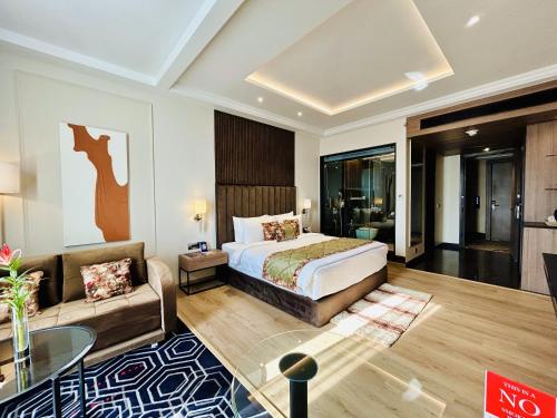 a hotel room with a bed and a couch at Fortune Ranjit Vihar, Amritsar - Member ITC Hotels' Group in Amritsar