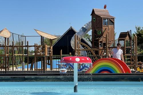 a man standing in the water at a playground at Chalet op vakantiepark Molenhoek in Kamperland