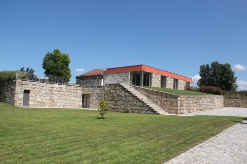 a stone wall with a house on top of it at PORTO - Penafiel - QUINTA DE SANTIAGO COUNTRY HOUSE in Penafiel