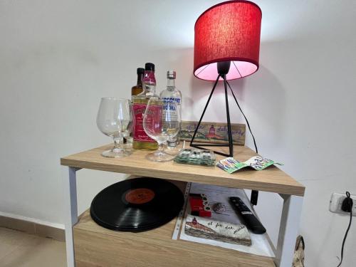 a table with a lamp and wine glasses on it at Bahía Golondrina in Ushuaia