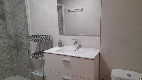 a white bathroom with a sink and a shower at Soria Naturaleza in Soria