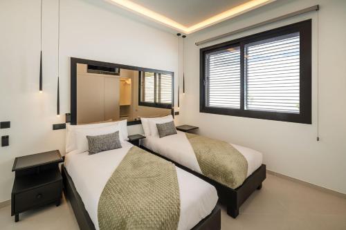 a bedroom with two beds and a window at TORO by Buenavilla in Puerto Calero