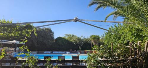 a metal canopy over a swimming pool with a swimming pool at Olympic Village Hotel & SPA in Olympia
