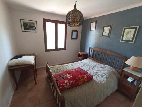 une chambre avec un lit, une table et une fenêtre dans l'établissement Maison Provençale avec jacuzzi, à Pierrevert