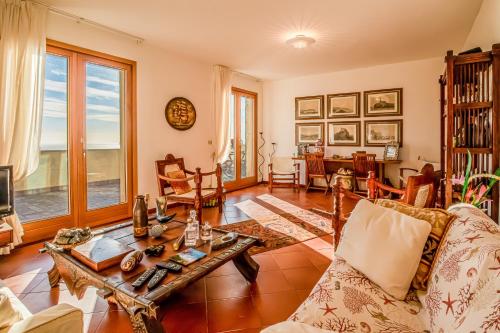 a living room with a couch and a table at Casa Aldrovandi in Capoliveri