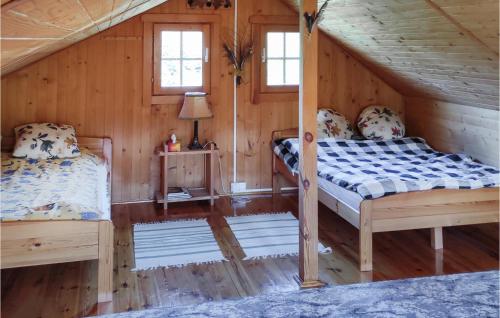 a bedroom with two beds in a log cabin at Pet Friendly Home In Wiselka With House A Panoramic View in Wisełka
