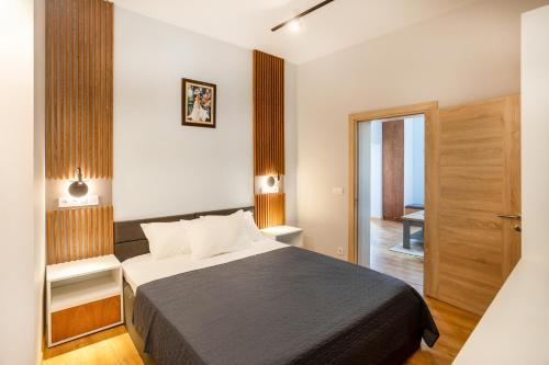 a hotel room with a bed and a hallway at Under The Hills in Plovdiv