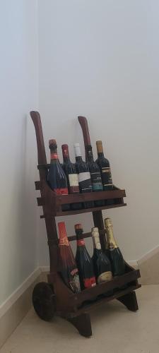 a bunch of wine bottles sitting on a shelf at Bed & Breakfast da Giovanni in Alessano