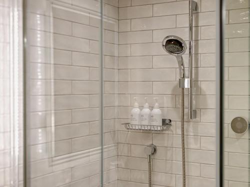 a shower with two bottles on a shelf in a bathroom at 2 Bed in Scarborough 79523 in Sawdon