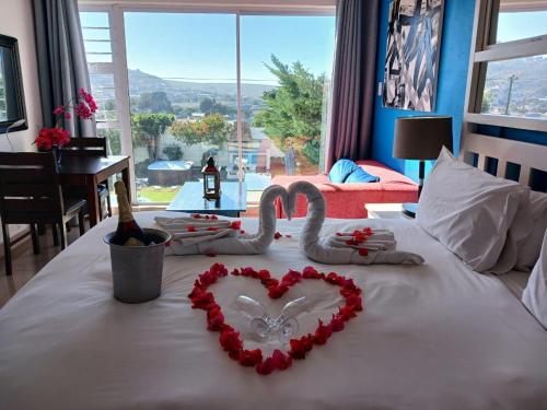 a bed with two swans made out of hearts at Saldanha Bay Lodge in Saldanha