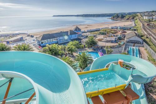 a view of the beach from a water slide at a resort at Manuka Cottage, stylish property with hot tub in Stoke Gabriel