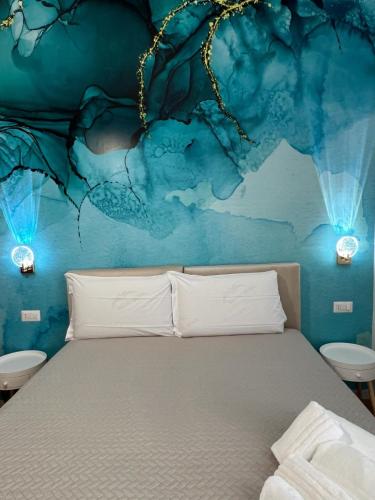 a bedroom with a bed with a blue wall at Le Corti del Re in Naples