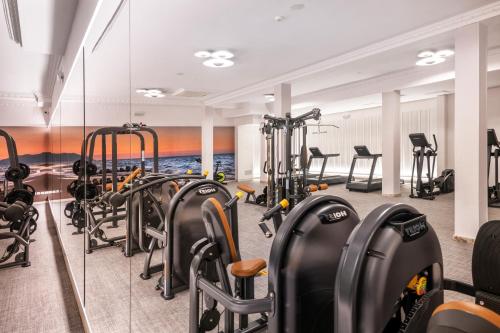 a gym with rows of treadmills and exercise bikes at Salles Hotels Marina Portals in Portals Nous