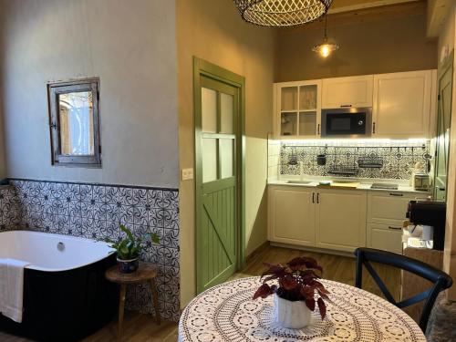 a kitchen with a table and a green door at Belaustegi turismo rural in Ispáster