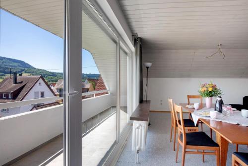 a dining room with a table and a large window at Ferienwohnung Lange in Waldstetten