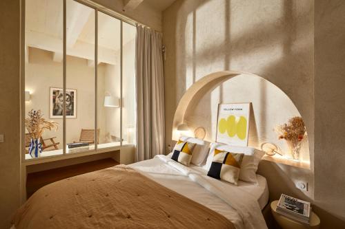 une chambre avec un grand lit et une fenêtre dans l'établissement Cosy 1BR with outside space neighboring Le Marais, à Paris