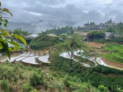 a river on the side of a hill at Pea homestay in Sa Pa