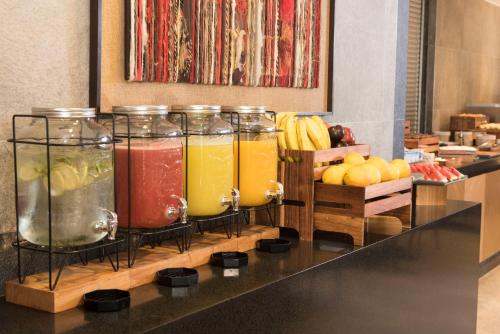 a group of four jars of juice on a counter at Holiday Inn Express - Temuco by IHG in Temuco