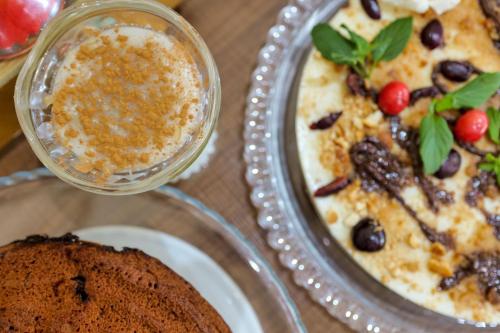 a table with a plate of food and a dessert at Hotel Oasis in Sarandë