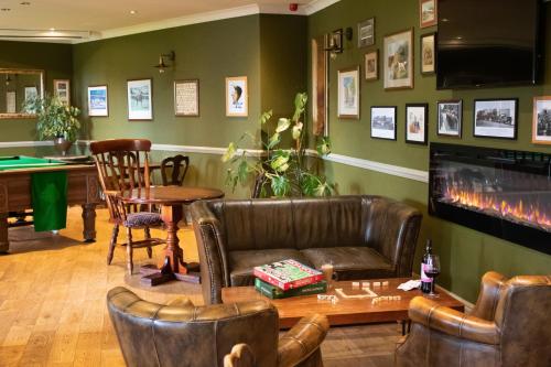 a living room with a couch and a table at The Dog and Partridge in Langsett