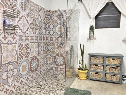 a bathroom with a tiled wall and a table at Knowhere Selfcatering Unit 1 in Omaruru