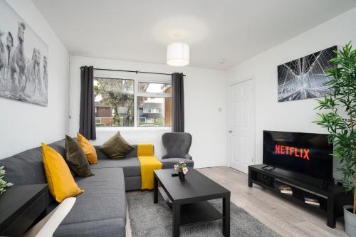 a living room with a couch and a tv at Large 3 Bed House - Free Parking- by Holiday Homes in Lincolnshire