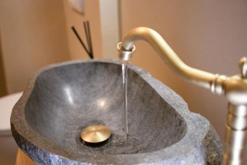 a metal sink with water coming out of it at ΠΥΡΓΟΣ ΜΠΕΧΡΑΚΗ-Μάνη in Pirgos Dhirou