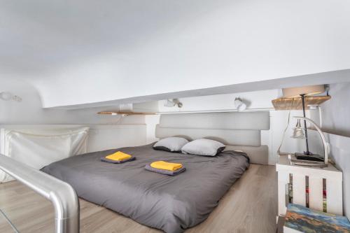 Studio cosy Aix en Provence في آكس أون بروفانس: غرفة نوم بسرير كبير وبها منشفتين صفراء