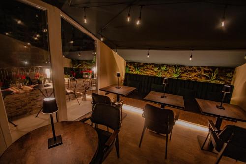 a restaurant with tables and chairs in a room at Vila Koja Boutique Hotel in Tirana