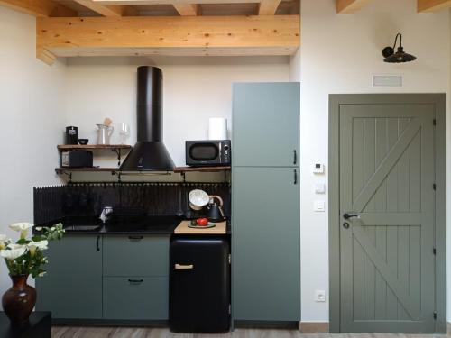 a kitchen with a white refrigerator and a door at Belaustegi turismo rural in Ispáster