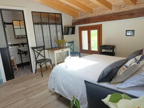 a bedroom with a bed and a desk and a kitchen at Belaustegi turismo rural in Ispáster