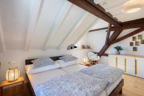 a bedroom with two beds in a attic at Quellenhof Südschwarzwald in Murg
