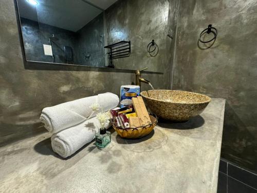a bathroom with a sink and a counter with a bowl at Ipoh Zing Vale - Family & Couple Suite in Ipoh
