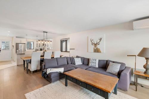a living room with a couch and a table at Spacious Condo with Lake and Mountain View in Mont-Tremblant