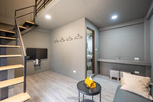 a living room with a staircase and a couch at East Star B&B in Xiaoliuqiu